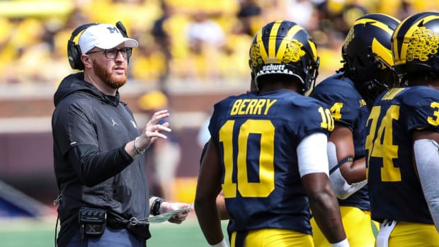 Michigan special teams coach Jay Harbaugh speaks to players.